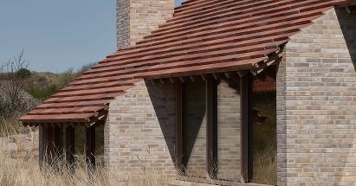 Unknown Architects sinks timber cabin into dune-filled Dutch island