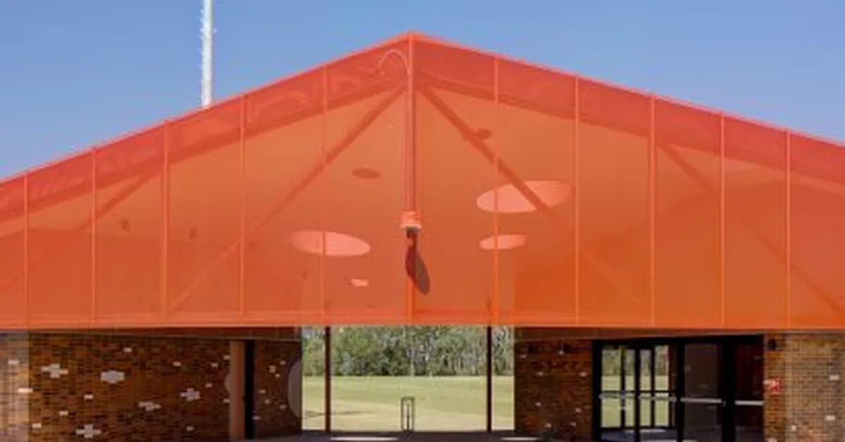 Ancient clay ovens inform red-toned sports pavilion by Sam Crawford Architects