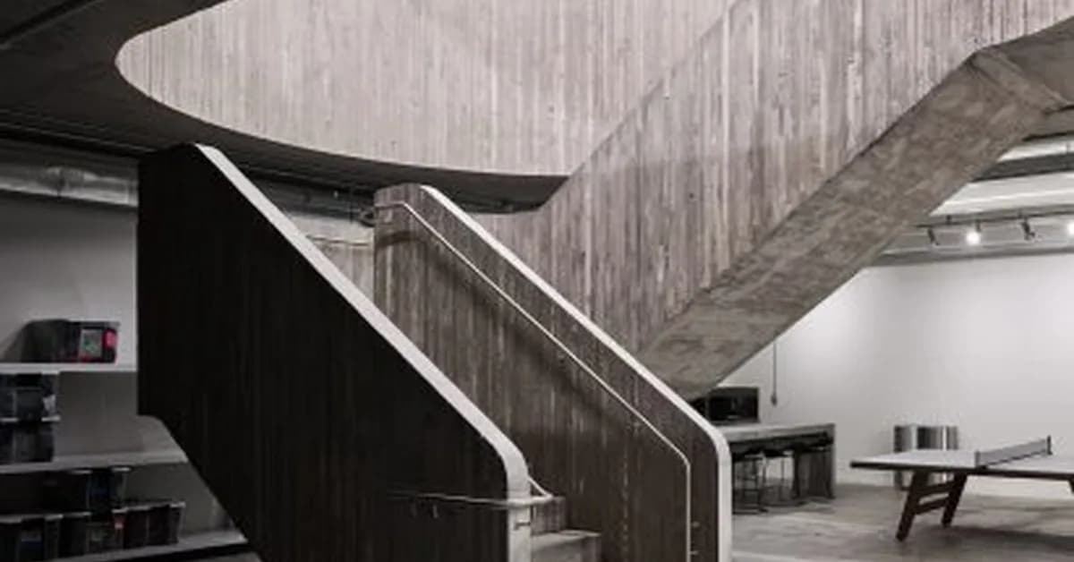 Concrete staircase anchors Purple Brand studios by Scott & Scott Architects