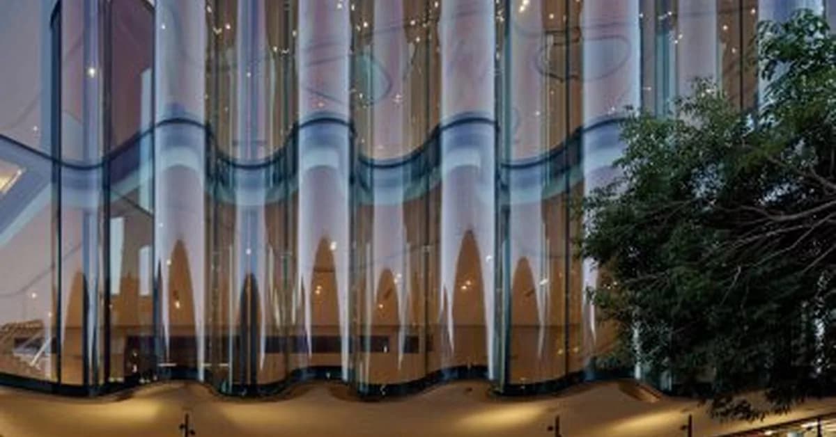 Seven buildings draped with fabric-like glass facades