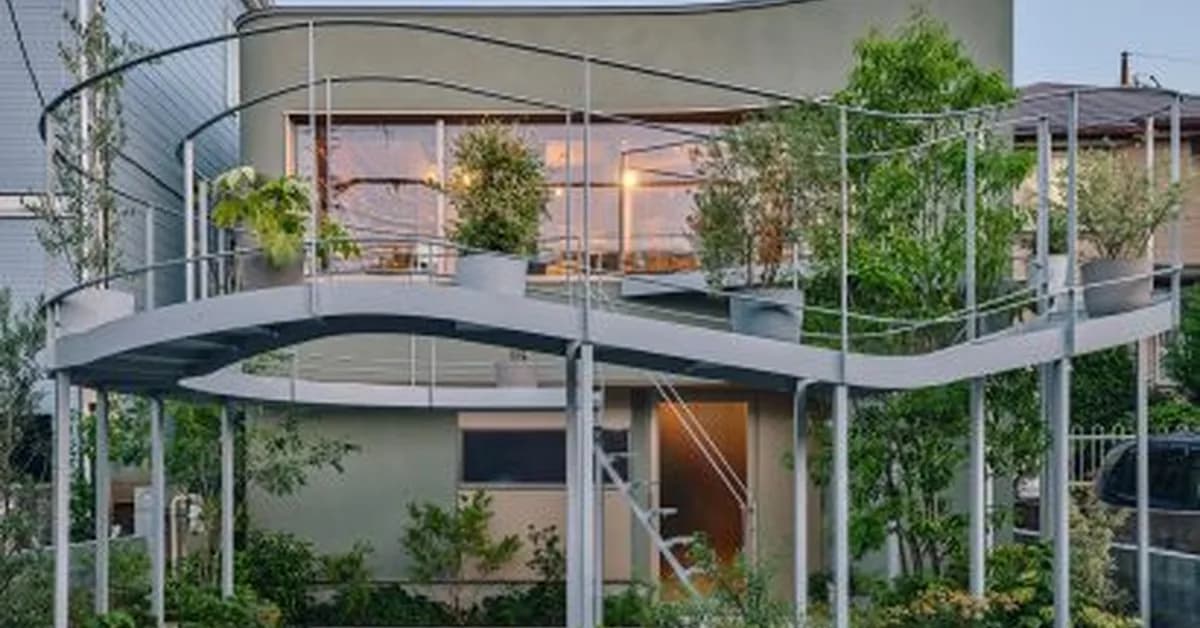 Curving metal terrace for potted plants fronts home in Tokyo by HOAA